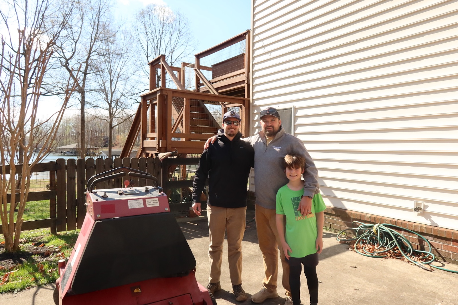 Reece (left) and Trey (right) Schnippel — the brothers behind Liaisly — with Trey's son at a Lake Anna property.